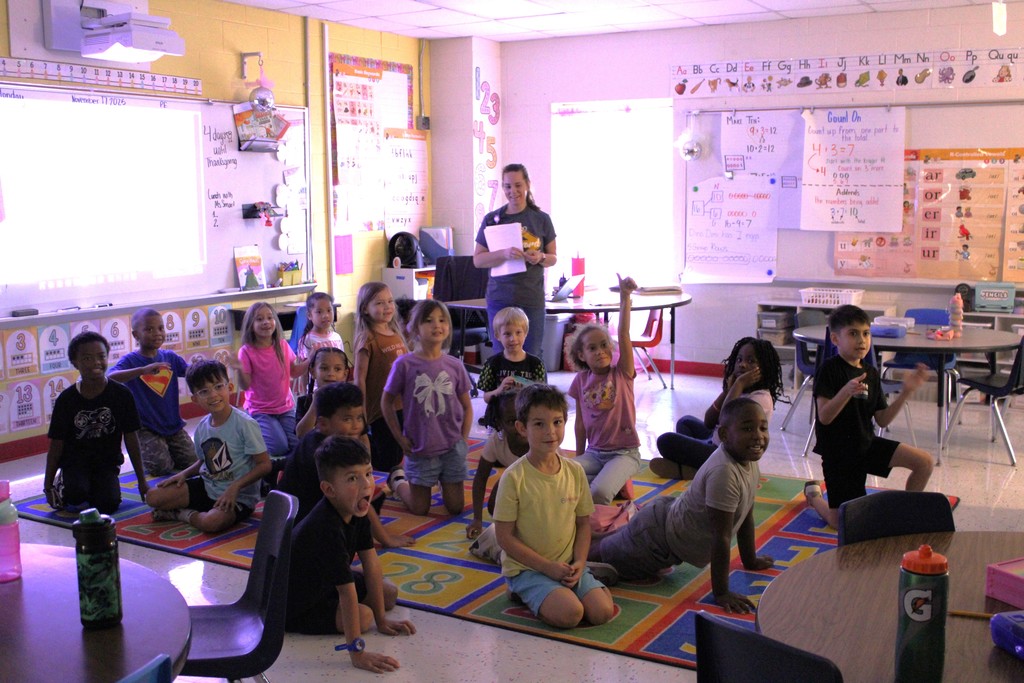 Student sitting on carpet learn that their class won