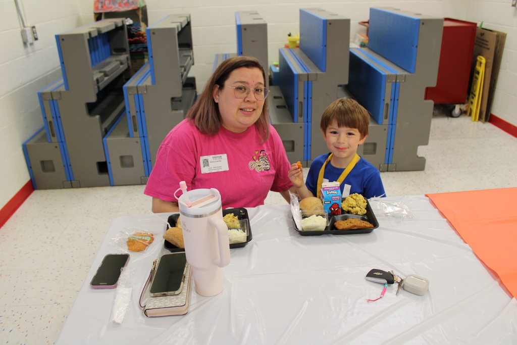 Student pose with parents for Thanksgiving feast