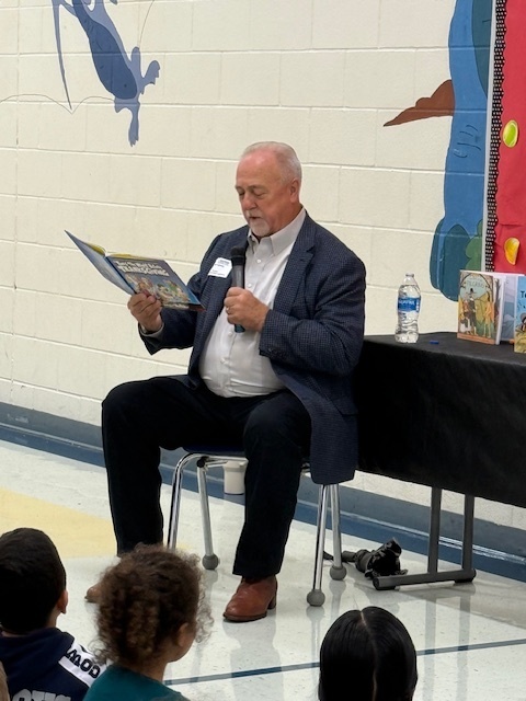 Man reading to a crowd of students