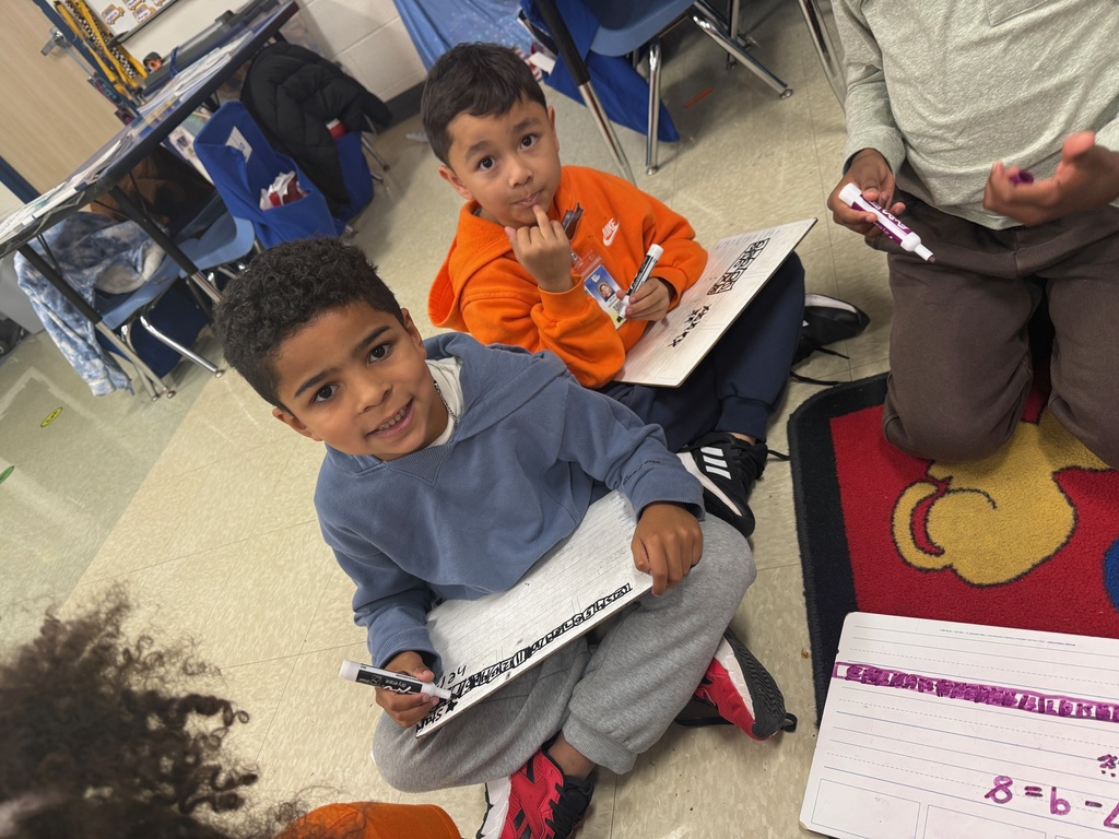Students smiling during a math activity