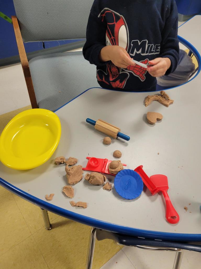 Making  gingerbread men out of PalyDoh