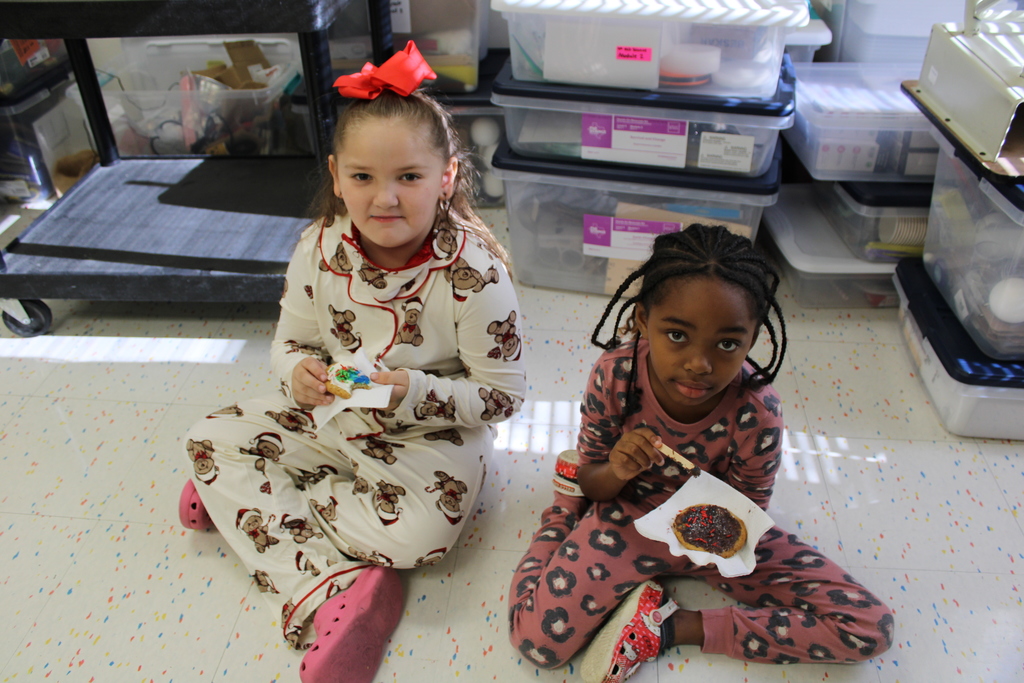 students pose with decorated cookies