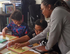 A teacher helping a student with an activity