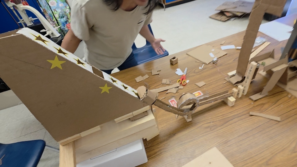 Physics students creating a Rube Goldberg machine