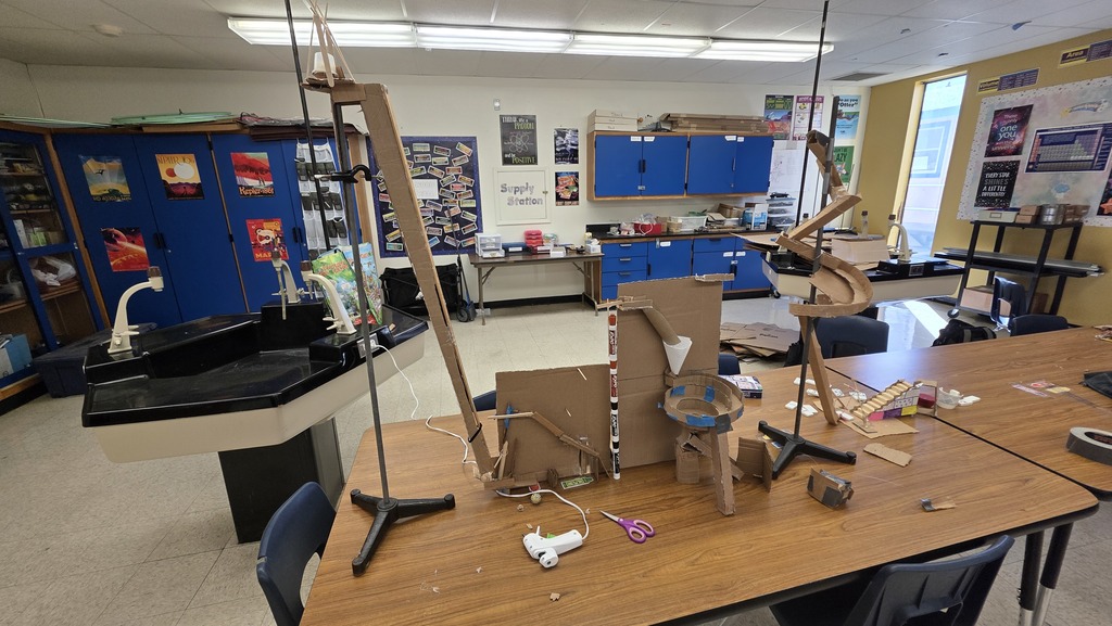 Physics students creating a Rube Goldberg machine