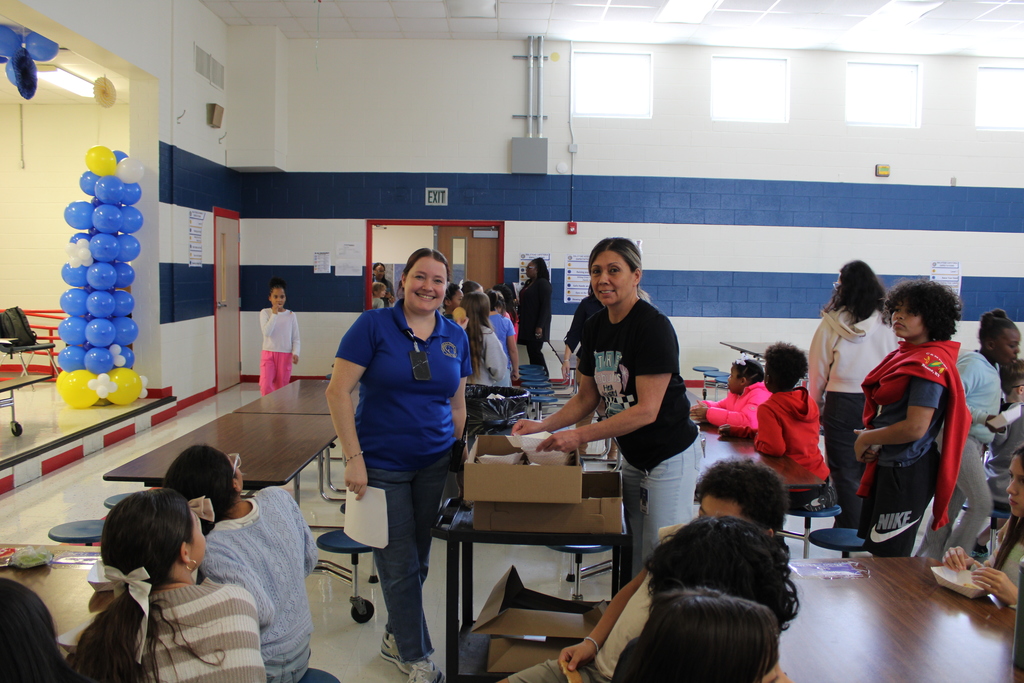 Staff pose while handing out cookies
