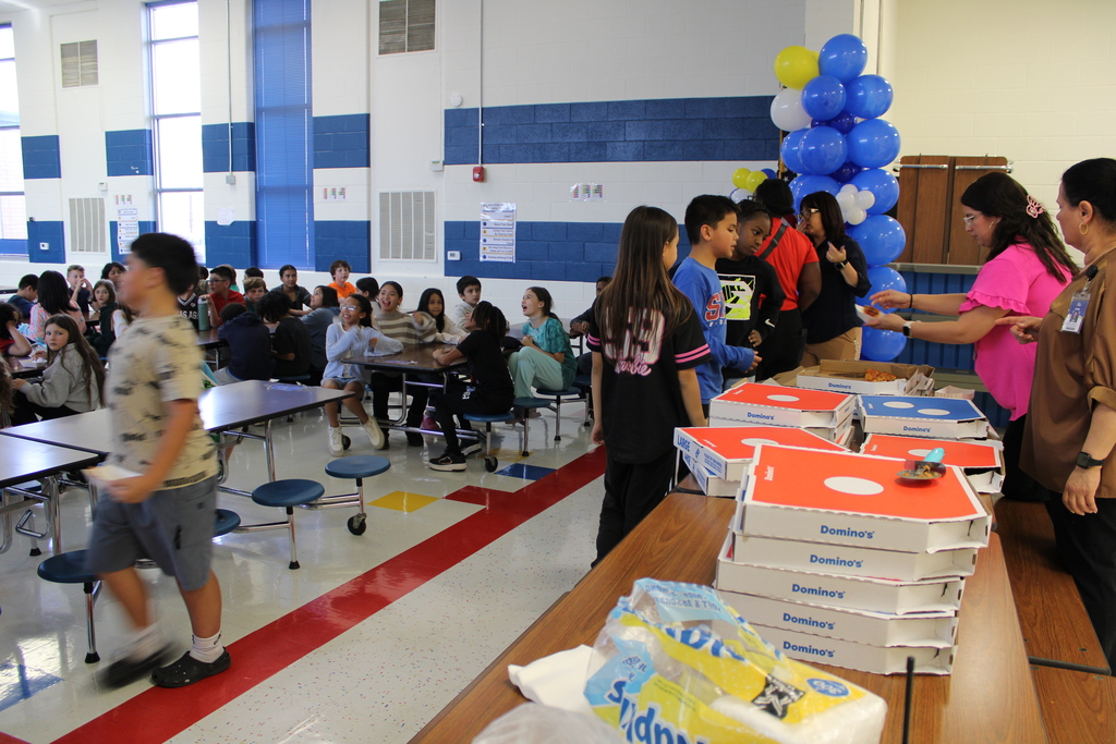 Students line up to receive pizza