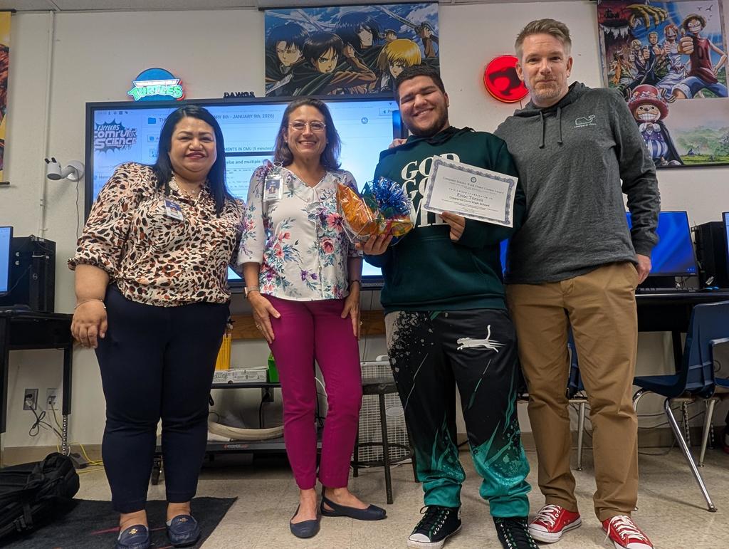 A student and three teachers smiling