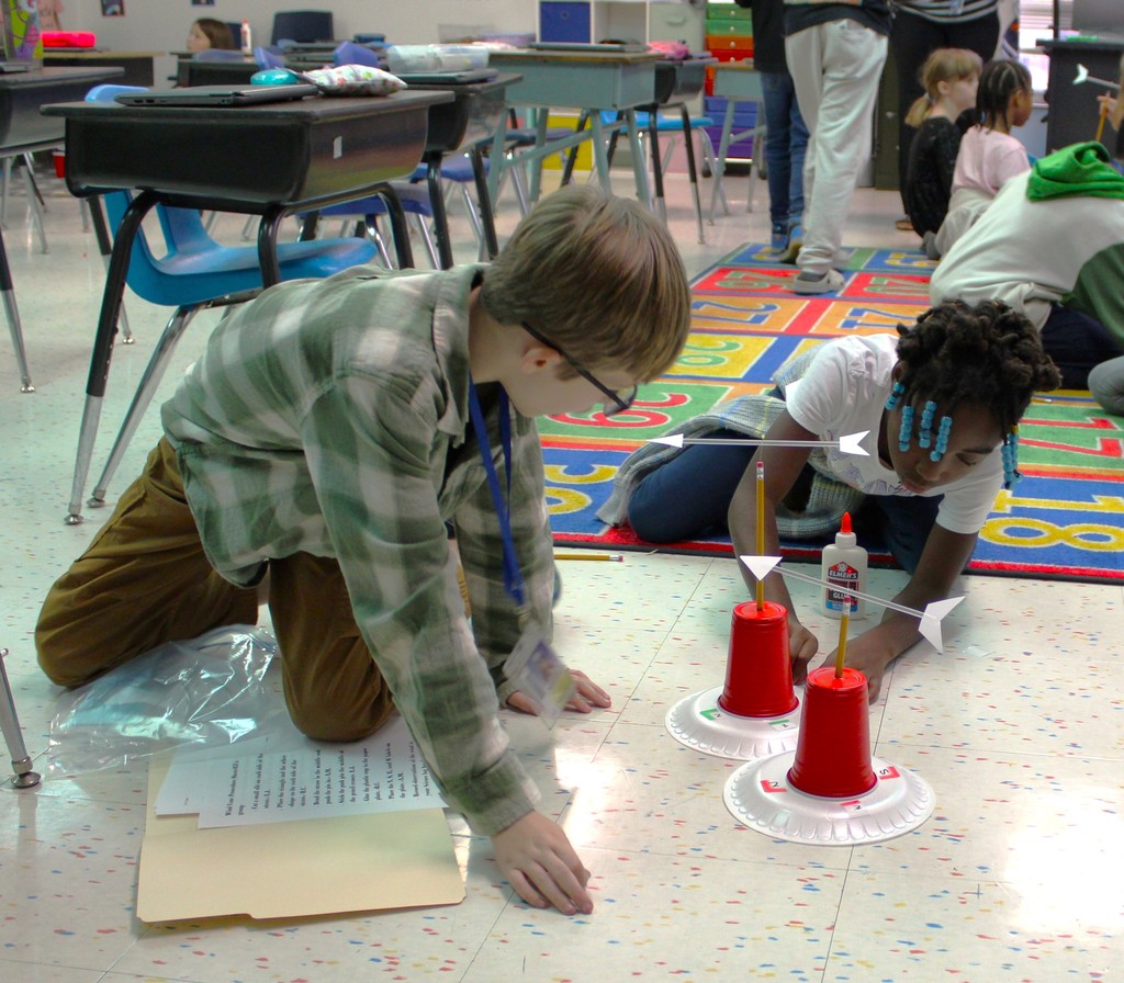 Students work on floor building weather vanes