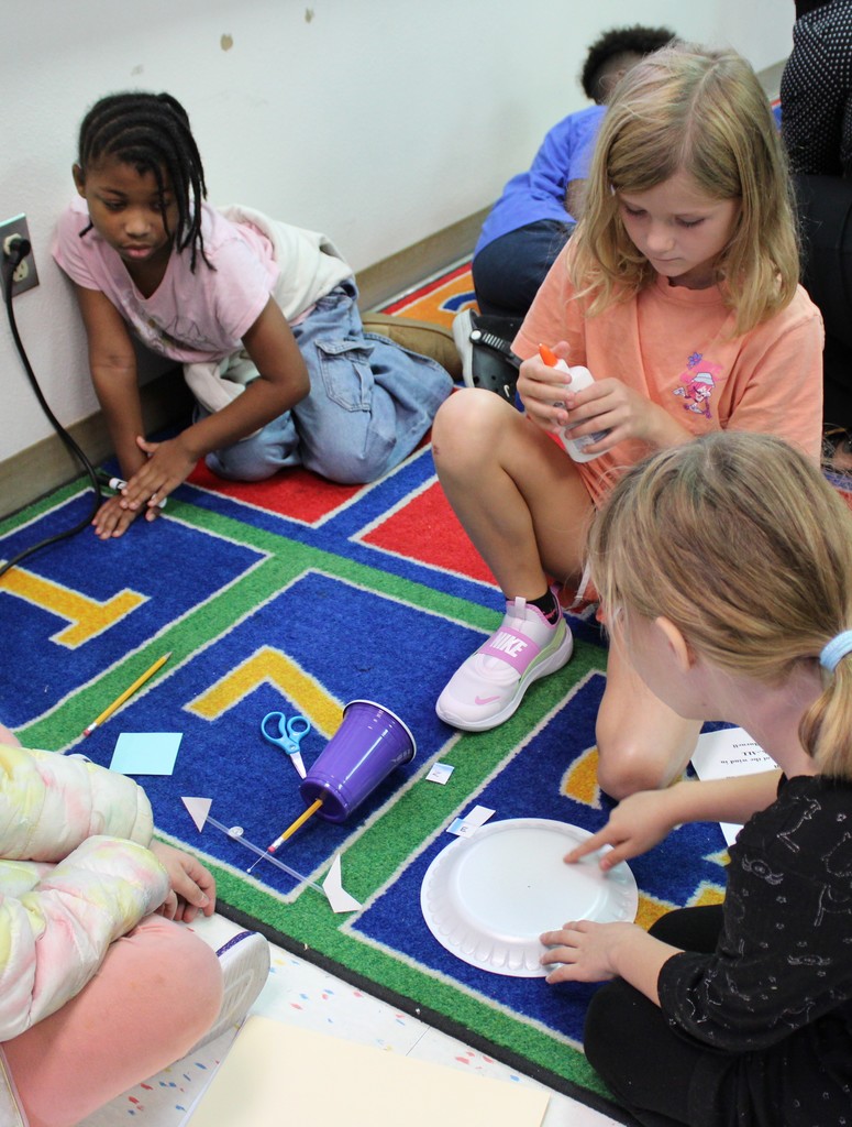 Students work on floor building weather vanes