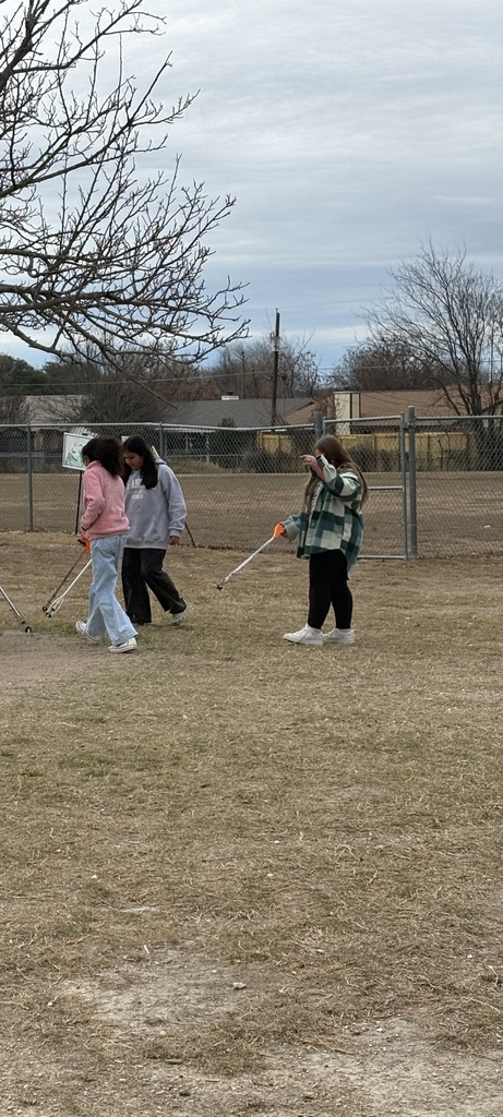 Students cleaning up trash around our campus