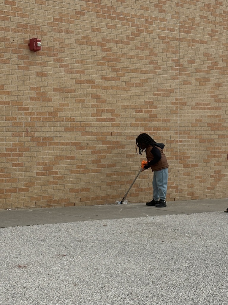 Students cleaning up trash around our campus