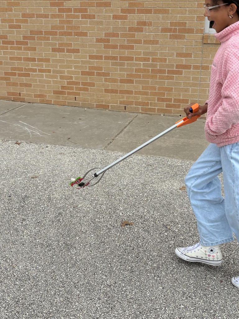Students cleaning up trash around our campus