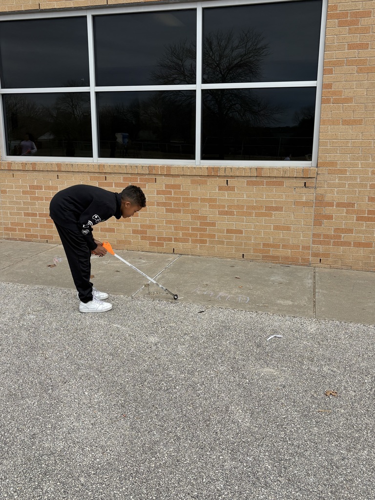 Students cleaning up trash around our campus