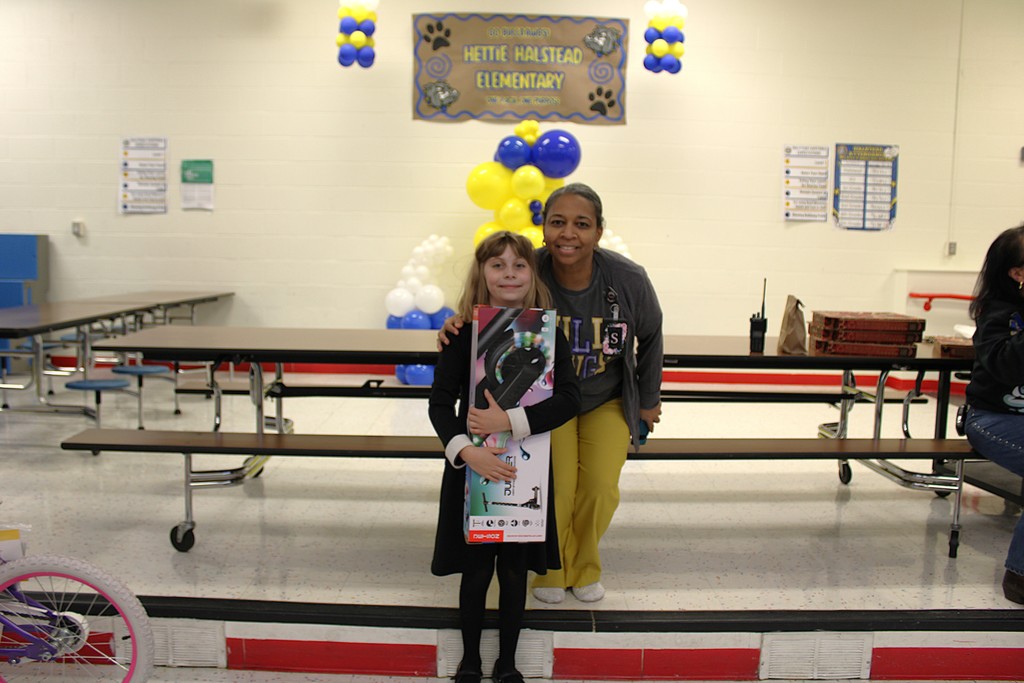 Dr. Sweeney and raffle winner student pose 