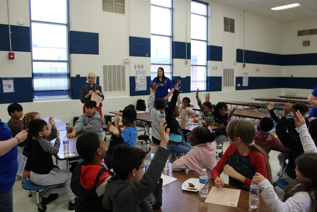 Students raise hands to vote for food item
