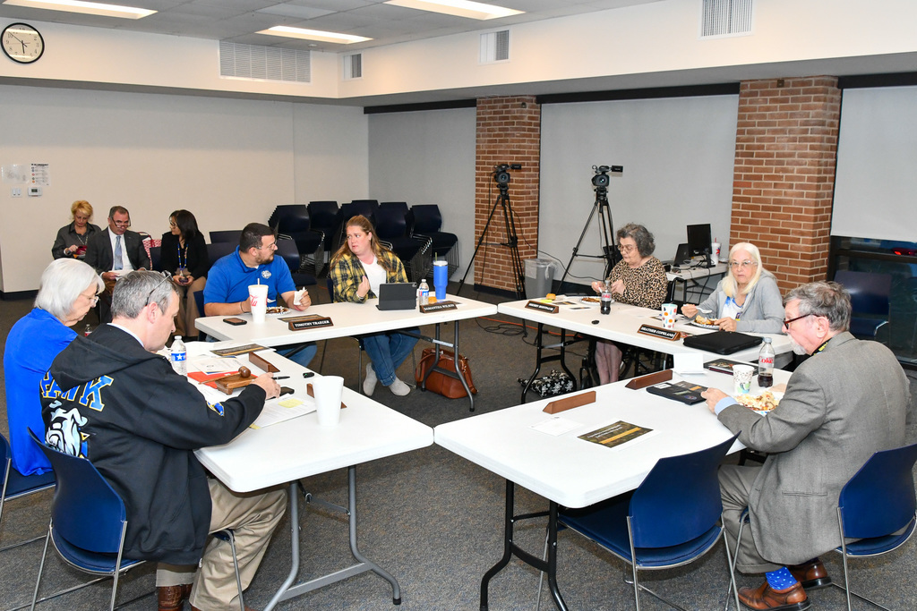 A group of people seated around a room eating