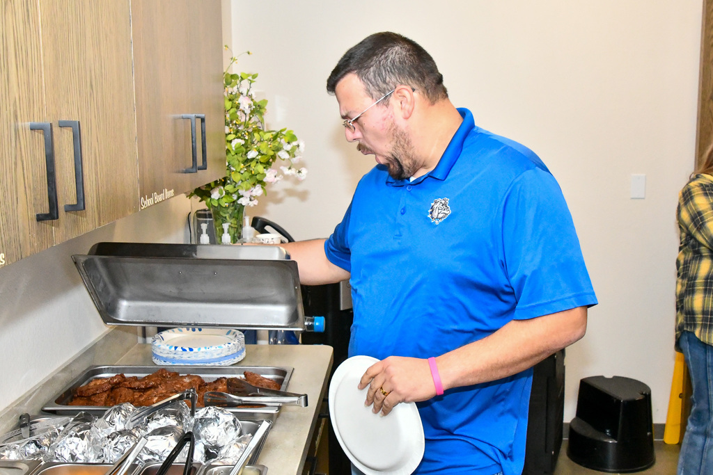 Man enthusiastically opening container with steaks in it