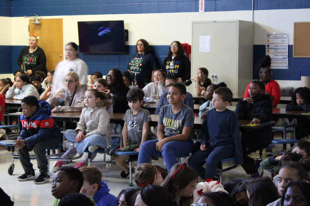 kids sitting at table singing
