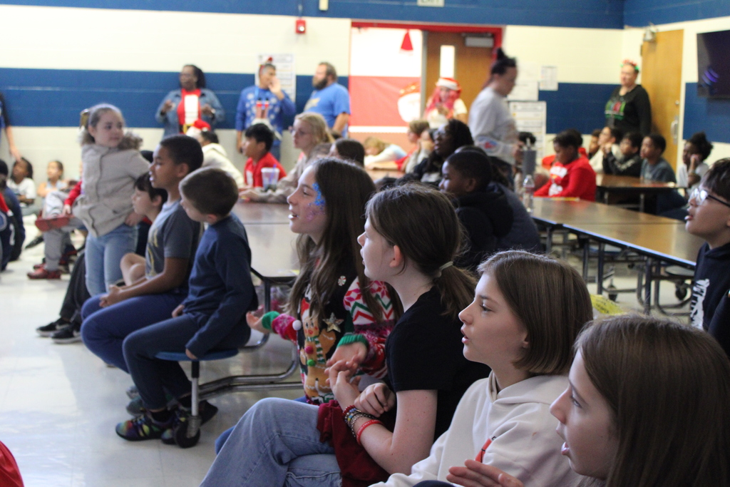 kids sitting at table singing