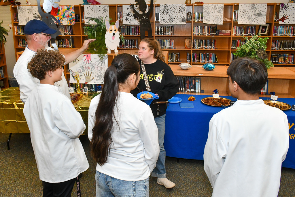 Trustee talking with a group of students