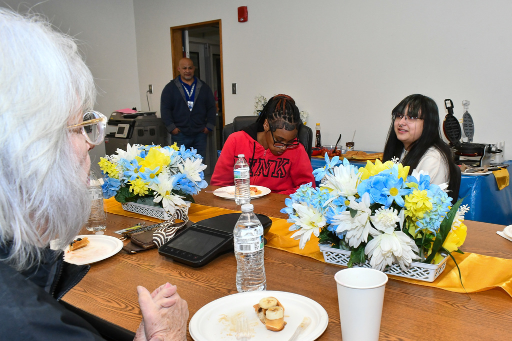 Two students talking with a board member