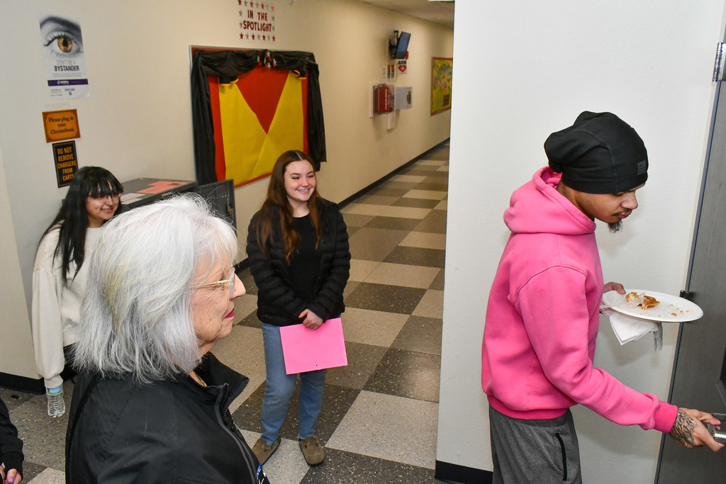 Three students giving a tour to a board member