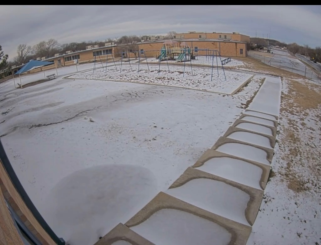 Photo of playground and concrete stairway covered in ice