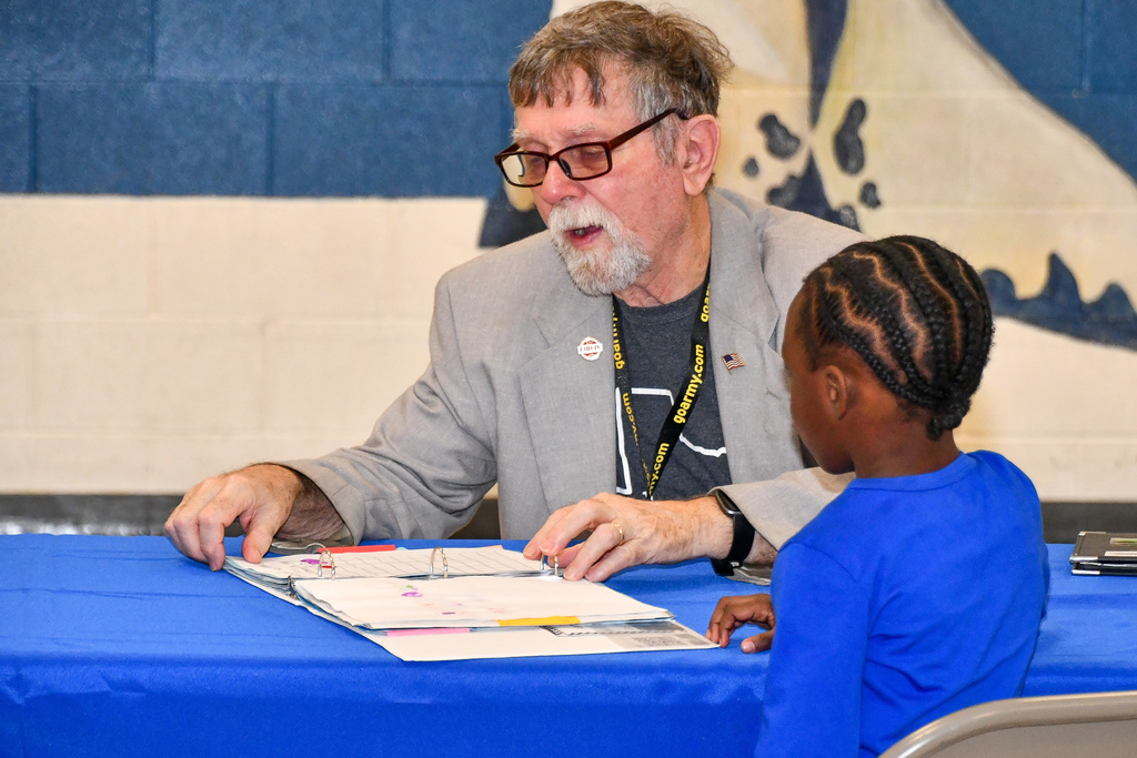 Photo of school board member talking with student