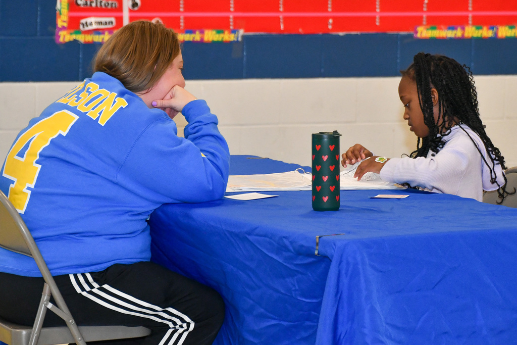 Photo of school board member talking with student