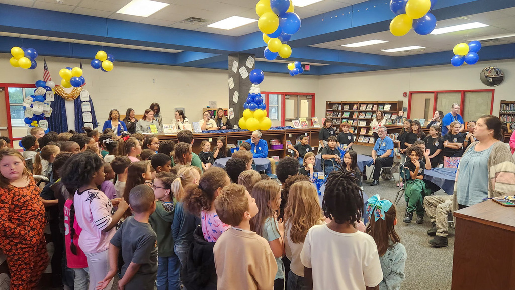A group of students performing for board members