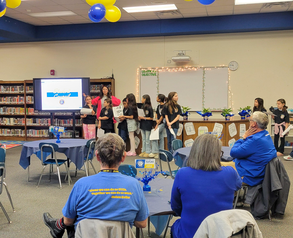 A group of students presenting to a group of trustees