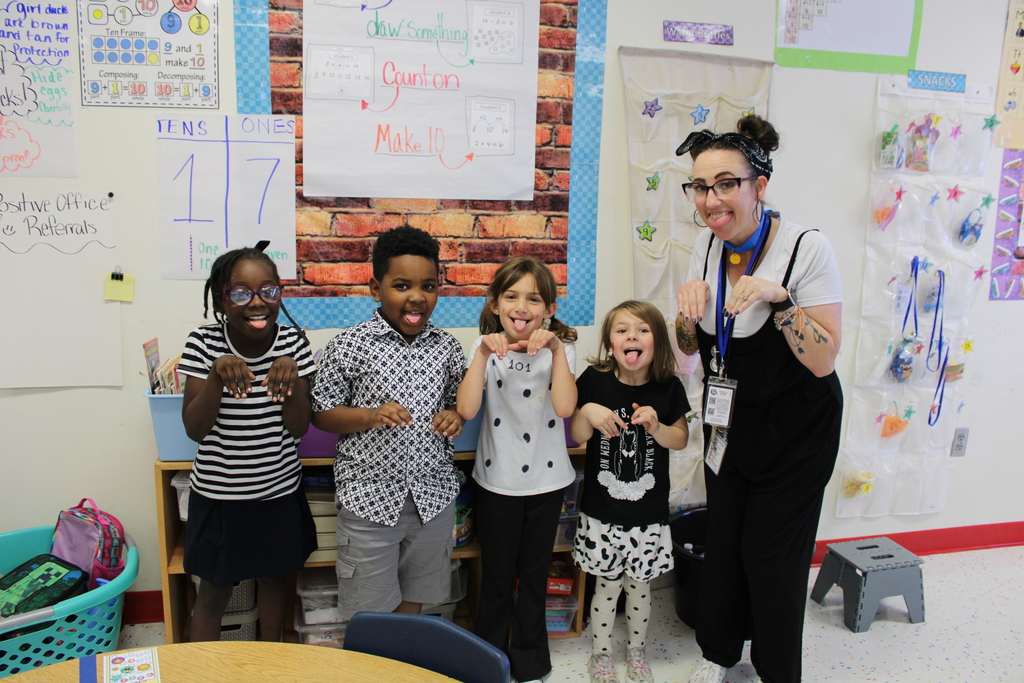 Students in dalmation spots pose for pictures