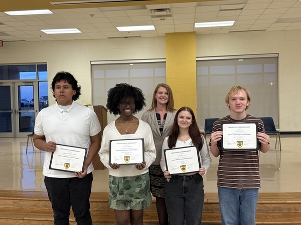 Picture of four students being inducted into the Science National Honor Society