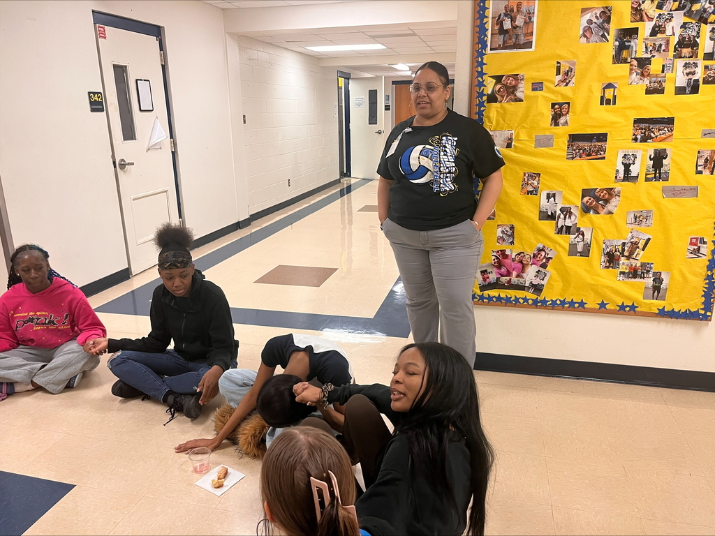 Students participating in a team building round table with Brendaliz Gomez