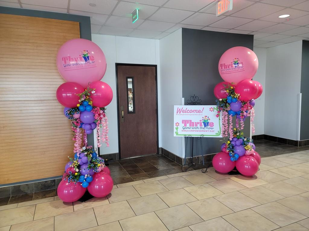 Pictures of colorful balloons surrounding a door at the THRIVE presenation