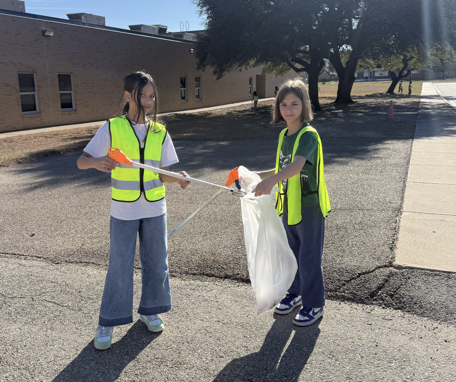 Students in safety vests cleaning our campus