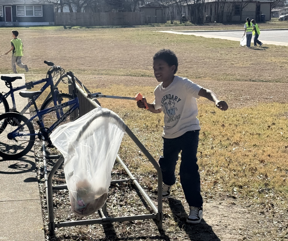 Students in safety vests cleaning our campus