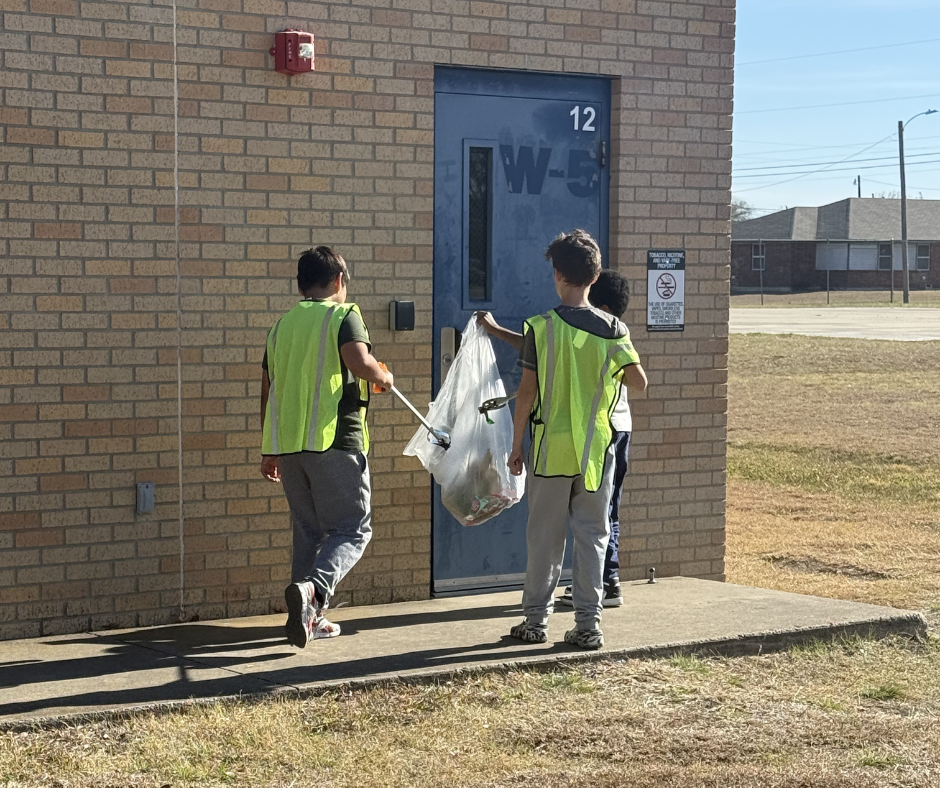 Students in safety vests cleaning our campus
