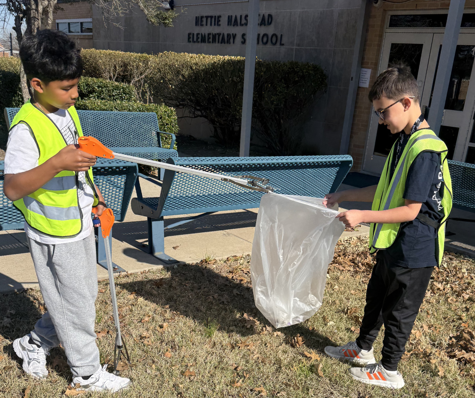 Students in safety vests cleaning our campus
