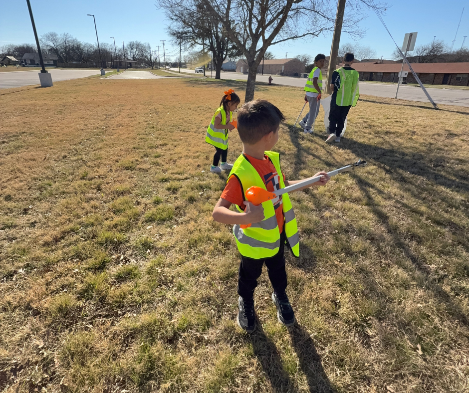 Students in safety vests cleaning our campus