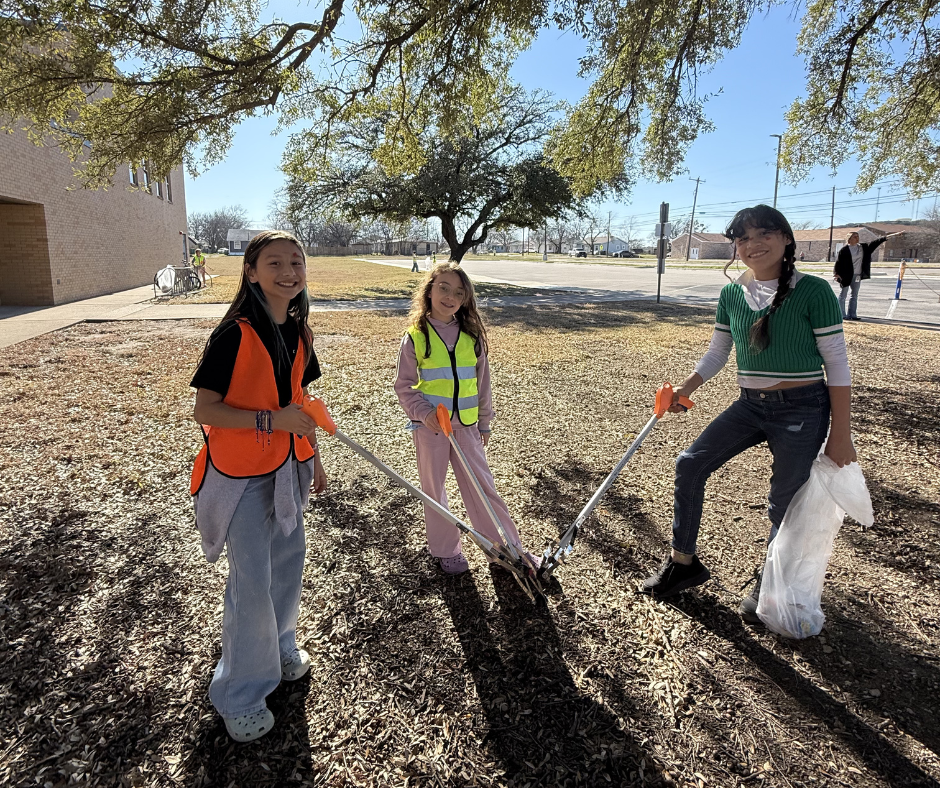 Students in safety vests cleaning our campus