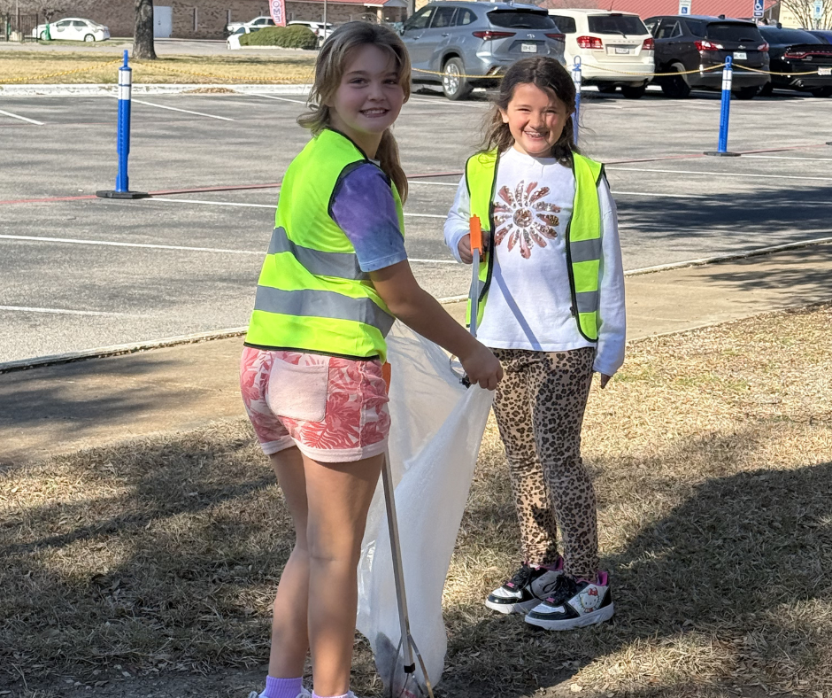 Students in safety vests cleaning our campus