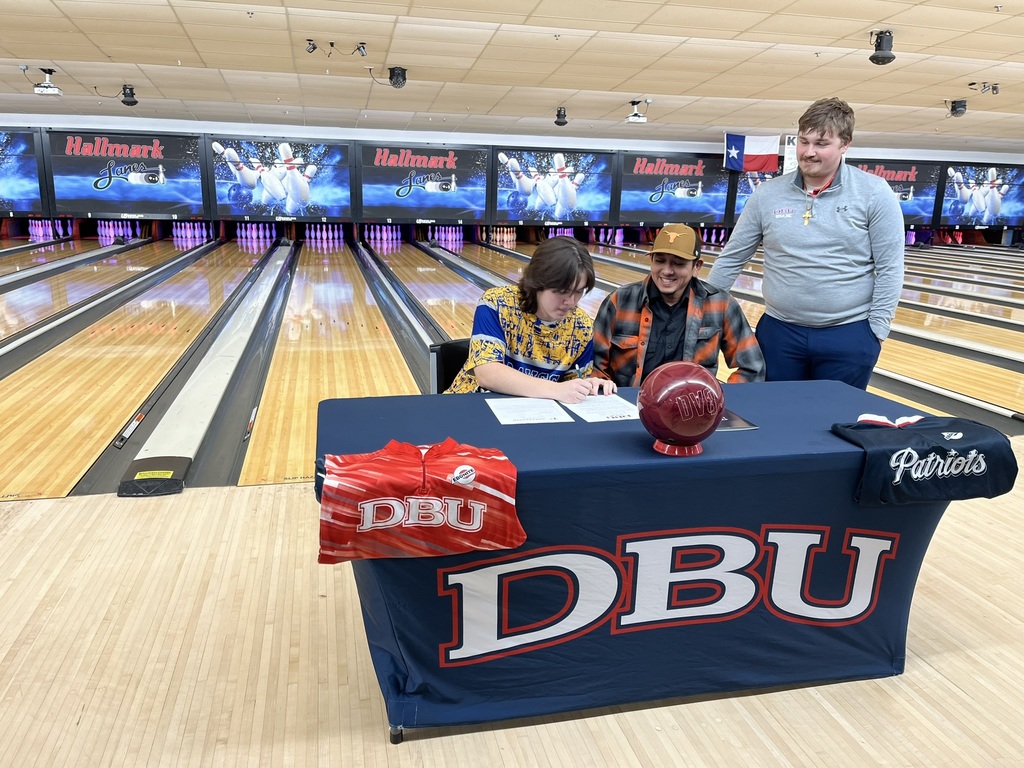 A student signing a college intent letter at the bowling alley. 