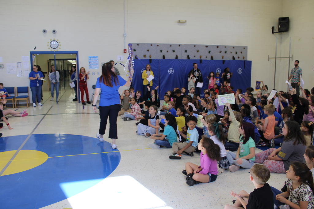 Mrs. Brown walks the gym to announce the winner of spirit stick