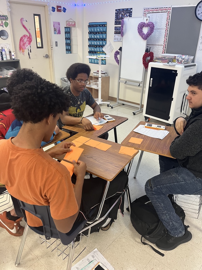 Students participating in a math puzzle for group work. 