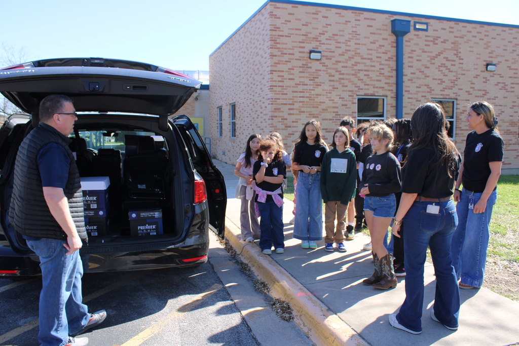 Stuco students load boxes into van