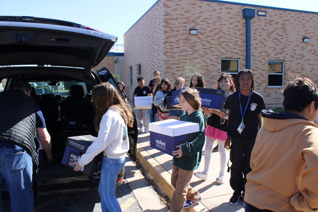 Stuco students load boxes into van