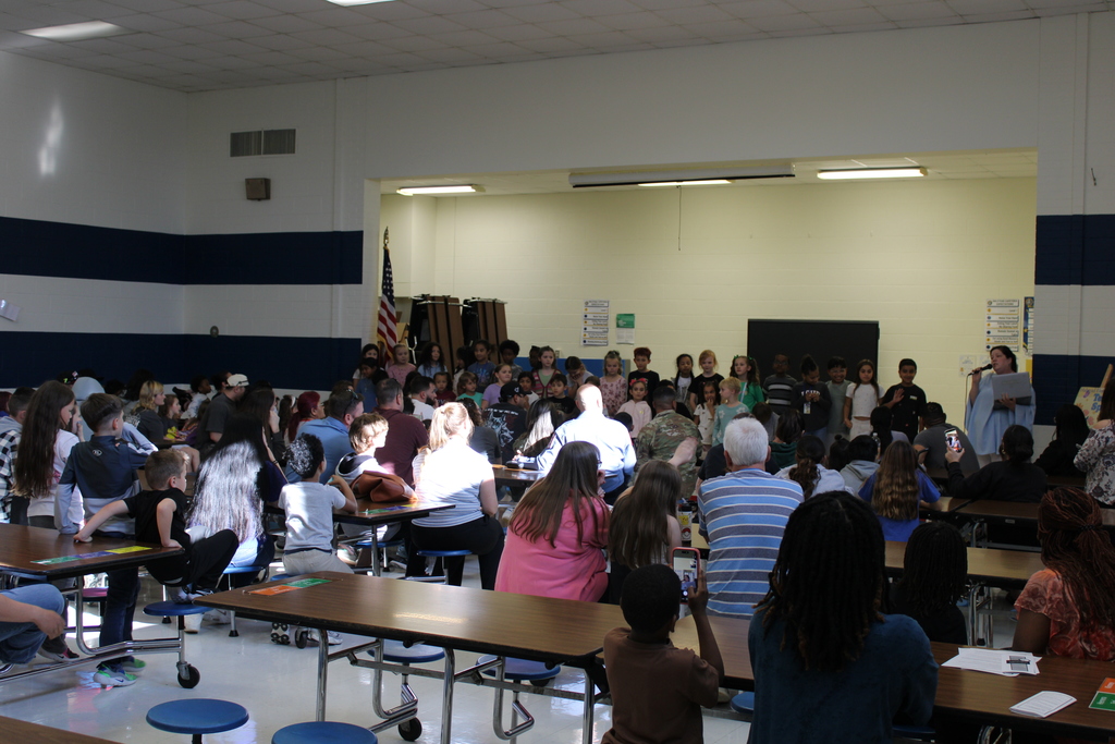 2nd grade class put on performance for open house to a crowded room of parents and families
