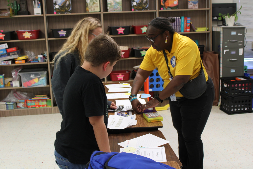 Parents and staff in classroom discussing students
